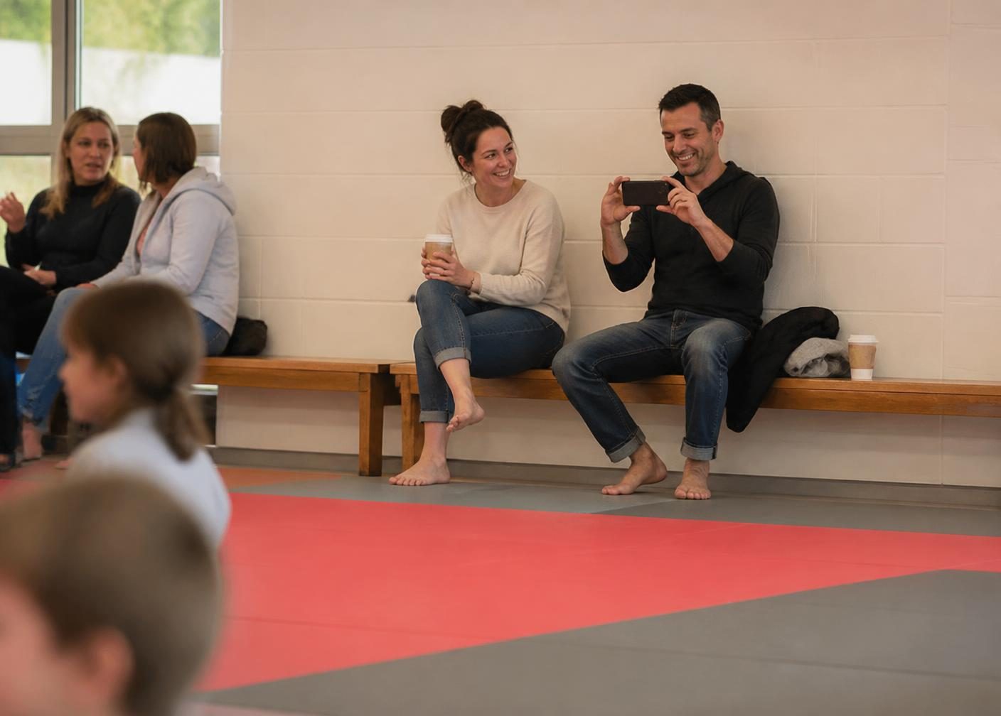 Happy parents relaxing and taking photos at a Go No Sen Karate birthday party in Peekskill